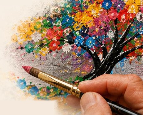 La mano del artista pintando un árbol de flores de colores